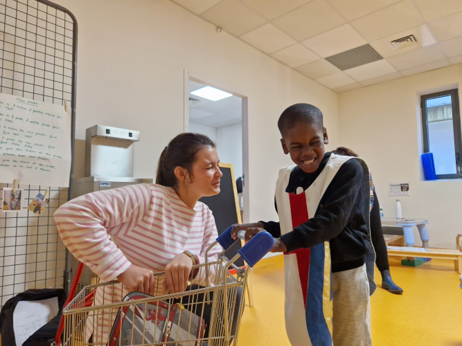 Enfant joue avec caddie de courses